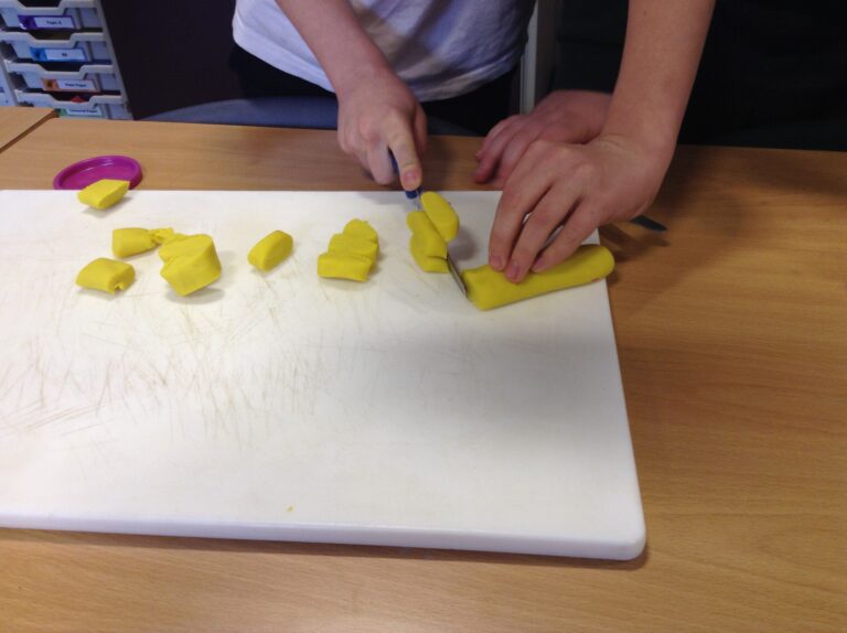 Making Pizza - We practice cutting with play dough.