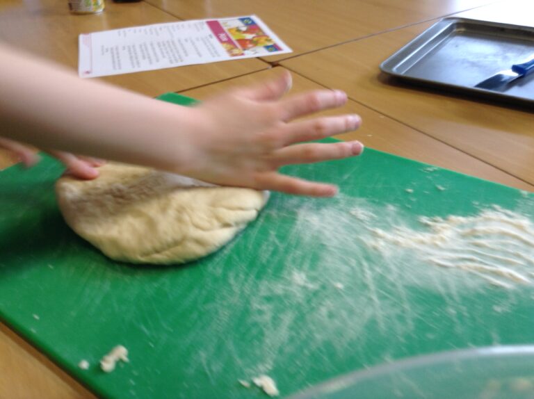 Making Pizza - Kneading our pizza dough.